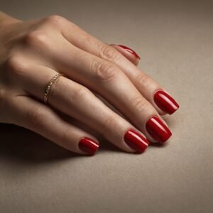 image of a hand with traditional red color acrylic nail